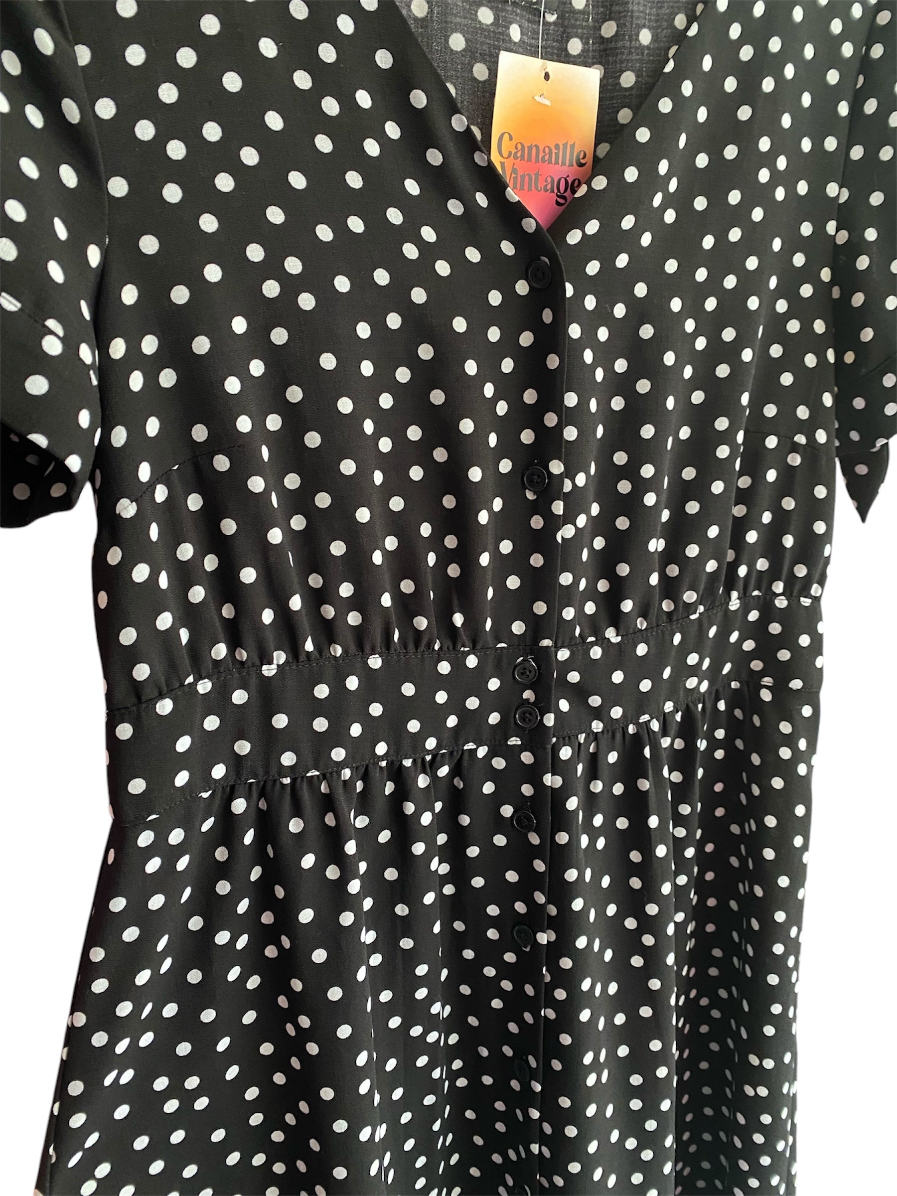 Robe noire à pois blanc de seconde main, vintage. Taille 36/38. Canaille Vintage - Friperie Bordeaux.