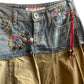 Jupe en jean Miss Sixty bi-matière à multiples détails : perles, breloques, broderies.
La jupe en jean vintage est à retrouver sur notre boutique en ligne ou directement dans notre friperie située dans le centre de Bordeaux.